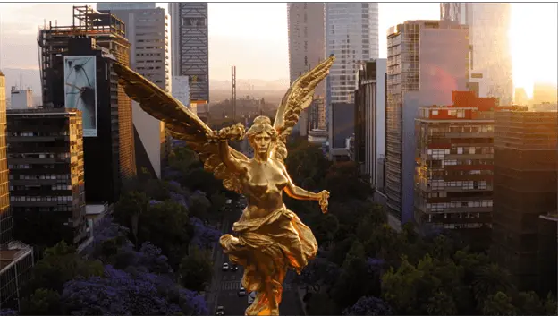 Sunset with a beautiful mexico city backdrop and the Angel of Independence statue shining brilliantly down on all the mexico city tech talent.