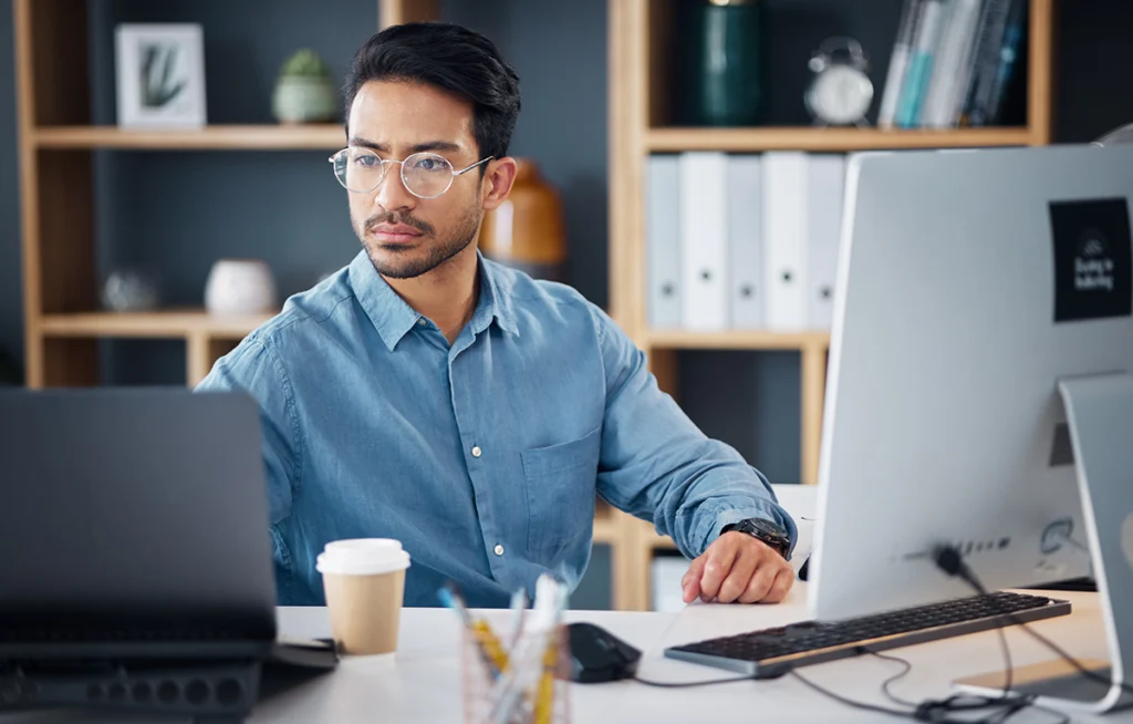 Latin American Salesforce Pod Member at desk, working hard for his team.