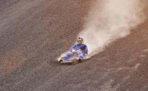 A man slides down a volcano in Nicaragua in the popular sport of volcano surfing