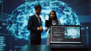Close up of notebook used by AI Engineer Staffing companies with two AI engineers in the background